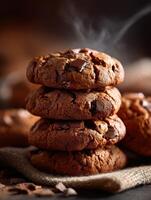 Freshly baked chocolate chip cookies stacked on a rustic burlap cloth photo