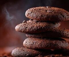 Chocolate cookies stacked on a wooden surface with steam rising in warm light photo