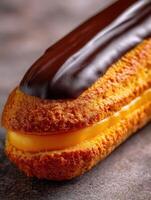 Delicious pastry filled with cream and topped with rich chocolate glaze photo