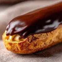 Decadent chocolate eclair with creamy filling on a soft pastry base photo