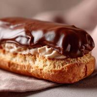 Delicious chocolate eclair topped with rich icing and creamy filling photo