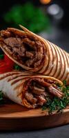 Delicious wraps filled with savory beef and fresh vegetables on wooden board photo