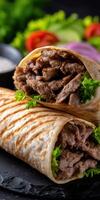 Delicious grilled meat wraps with fresh vegetables served on a black plate photo