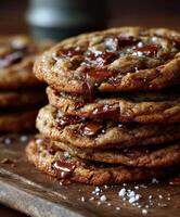 Freshly baked chocolate chip cookies stacked on a wooden board photo