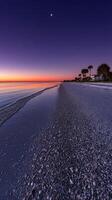 Sunset over serene beach with gentle waves and a distant moon photo