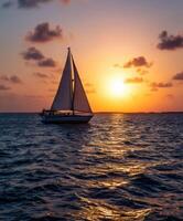 Beautiful sailing boat at sunset on tranquil waters in summer evening photo