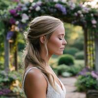 Bride in serene moment during outdoor wedding ceremony photo
