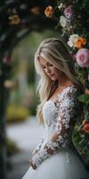 Beautiful bride in nature surrounded by floral decorations photo