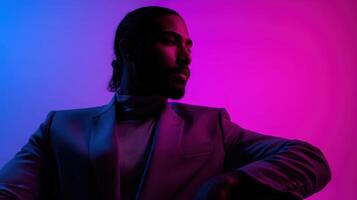 Stylish man poses in artistic blue and pink lighting photo
