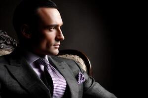 Sophisticated man in a tailored suit seated in elegant style photo