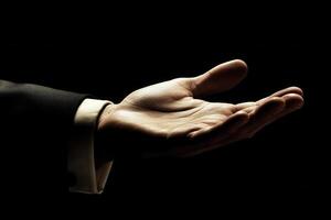 Elegant open hand gesture in low light, symbolizing invitation or offering photo