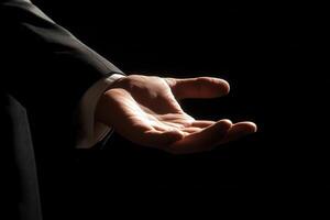 Elegant outstretched hand in a dark setting, symbolizing invitation or offering support photo