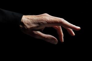 Elegant hand reaching out against a dark background, showcasing gracefulness and detail photo