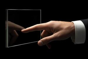 Elegant hand reaching towards a transparent glass panel in a dark environment, symbolizing innovation photo