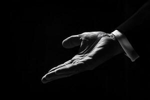 Elegant black and white image of a hand reaching out, symbolizing invitation or assistance photo