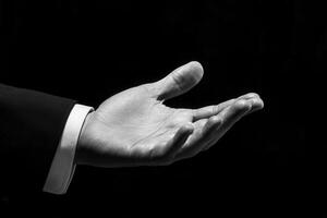 Elegant outstretched hand in a formal setting, symbolizing invitation and connection photo