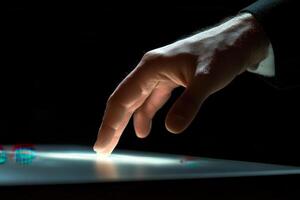 Close-up of a human hand reaching towards a glowing surface, highlighting interaction and technology photo