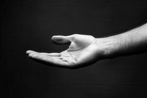 A close-up of an open hand against a dark background, symbolizing invitation or offering photo