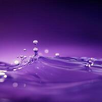 Close-up of water droplets splashing in vibrant purple liquid, creating dynamic patterns photo