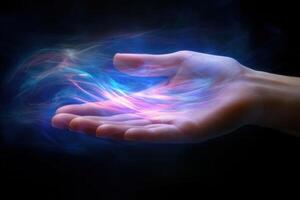 A human hand reaching out with colorful energy waves emanating from the palm in darkness photo