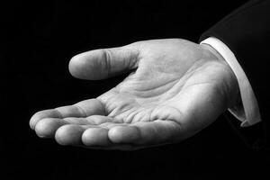 Elegant black and white image of an open hand, symbolizing invitation or assistance photo