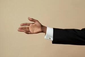 Elegant hand gesture in a formal suit against a neutral background, conveying invitation photo