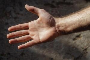Close-up of an outstretched human hand against a textured background, showcasing details photo