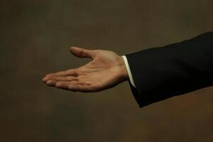 Elegant hand gesture reaching out against a blurred background, suggesting invitation or greeting photo
