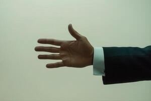 Elegant hand gesture in a formal suit against a soft background, conveying invitation photo