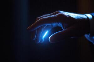Close-up of a human hand reaching towards a glowing light source in a dark environment photo
