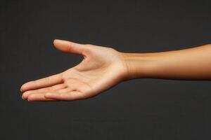 A graceful, outstretched hand reaching forward against a dark background, symbolizing invitation photo