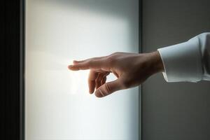 A hand reaching towards a glowing surface, symbolizing connection and innovation in a modern setting photo