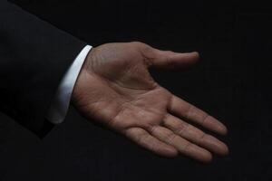 Elegant hand gesture extended in a professional setting, symbolizing invitation and connection photo
