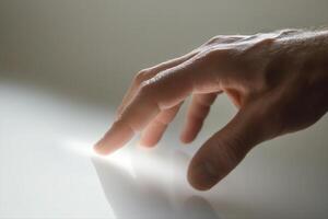 A close-up of a hand reaching towards a reflective surface, capturing a moment of curiosity photo
