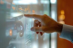 A hand interacting with a digital display showcasing data and analytics in a modern office photo