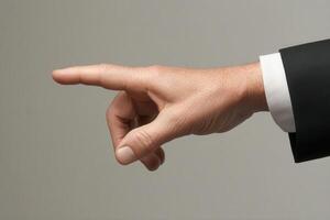 Elegant hand gesture in business attire signaling direction against a neutral background photo