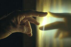 Close-up of a human hand reaching towards a glowing surface, symbolizing connection and discovery photo