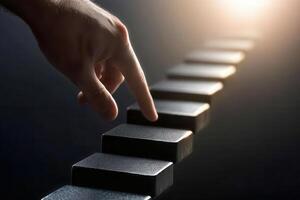A hand reaching out to touch a series of black blocks in a dimly lit environment photo