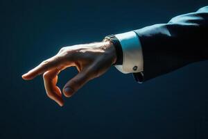 Elegant hand gesture in a suit against a dark background, suggesting invitation or action photo