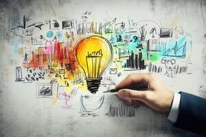 Creative hand sketching vibrant ideas and concepts on a wall with a glowing light bulb photo