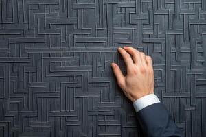 Elegant hand reaching out to textured gray wall, symbolizing sophistication and design photo