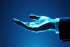 Elegant hand gesture in a business suit against a blue background, symbolizing opportunity photo