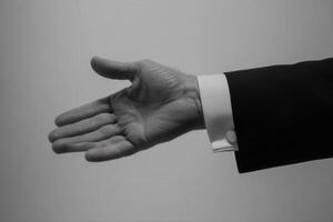 Elegant black and white image of a hand extending for a handshake, symbolizing greeting photo