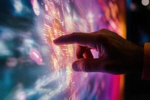 A close-up of a human hand interacting with a vibrant digital display of data visuals photo