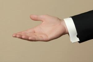 Elegant hand gesture in formal attire against a neutral background, suggesting invitation photo