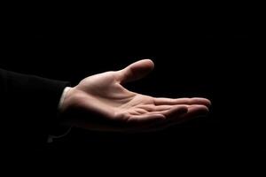 Open hand gesture in a dark setting, symbolizing invitation or assistance photo