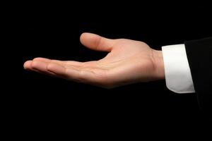 Open hand gesture against a black background, symbolizing invitation or offering photo