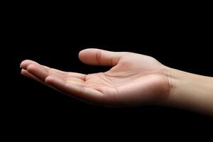 Open hand gesture against a black background, symbolizing offering or waiting for help photo