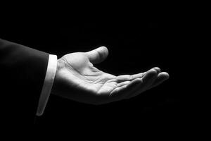 Elegant outstretched hand in black and white, symbolizing invitation or assistance photo
