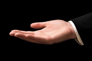Elegant outstretched hand in formal attire against a black background, symbolizing invitation photo